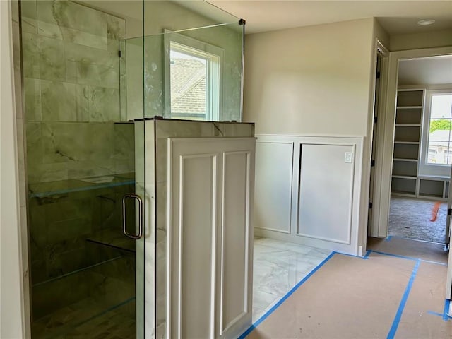 10303 W 151st Ter, Overland Park, KS 66221 - bathroom featuring a decorative wall, a shower stall, and a wainscoted wall