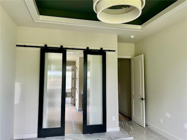 10303 W 151st Ter, Overland Park, KS 66221 - spare room with a barn door and a raised ceiling