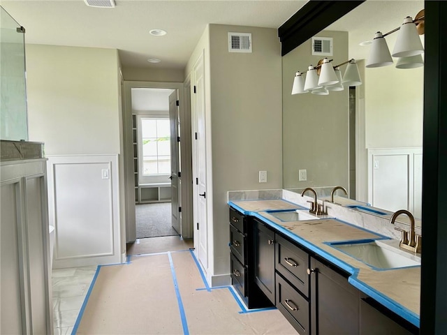 10303 W 151st Ter, Overland Park, KS 66221 - full bathroom featuring double vanity, a wainscoted wall, and recessed lighting