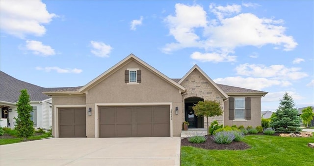 view of front of home featuring a garage, concrete driveway, stucco siding, a front yard, and stone siding