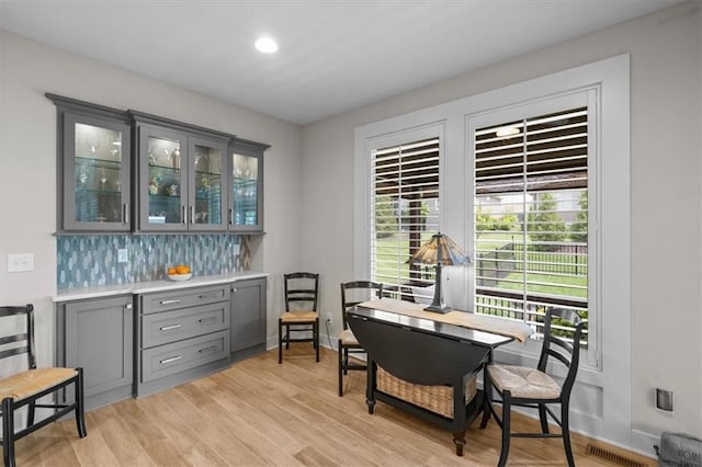 dining space with light wood-type flooring, recessed lighting, an office area, and baseboards