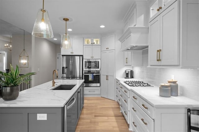 kitchen featuring stainless steel appliances, a sink, gray cabinetry, backsplash, and recessed lighting