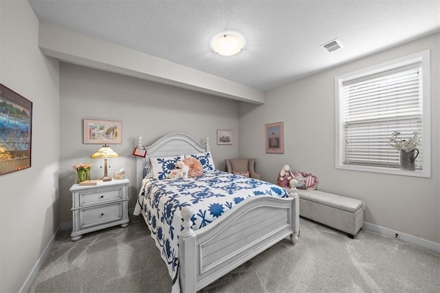 carpeted bedroom featuring baseboards and a textured ceiling