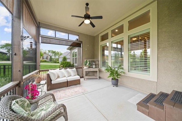 sunroom / solarium with a ceiling fan and an outdoor hangout area