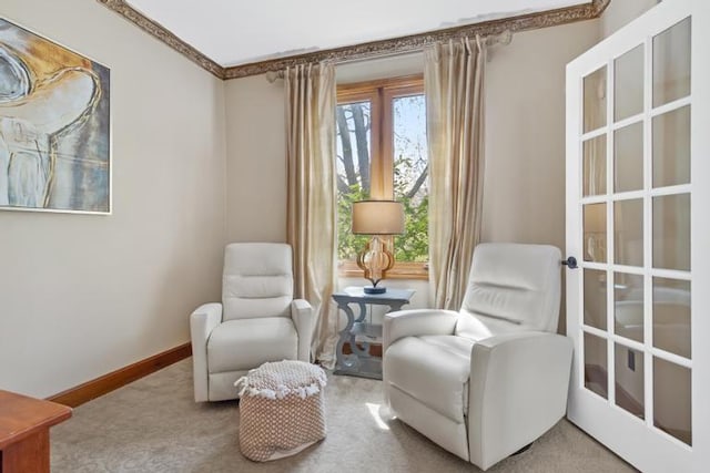 sitting room featuring carpet floors, baseboards, and plenty of natural light