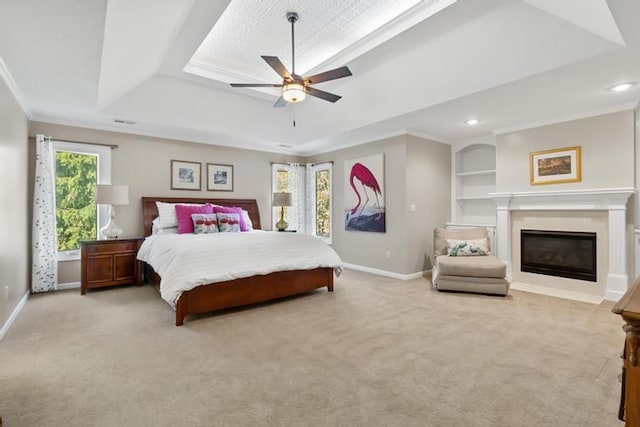 bedroom featuring baseboards, a tray ceiling, and light colored carpet
