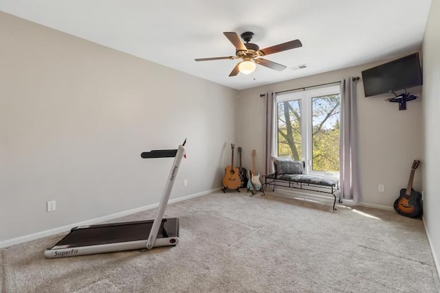 workout area featuring carpet floors, baseboards, a ceiling fan, and visible vents