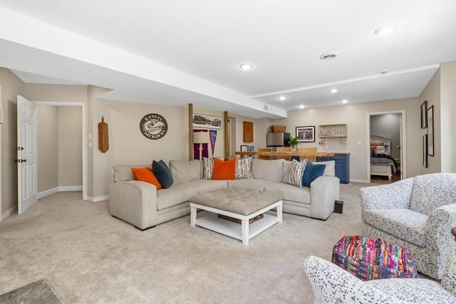 living area featuring recessed lighting, baseboards, and light colored carpet