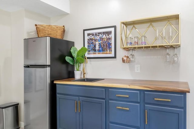 bar with freestanding refrigerator and a dry bar