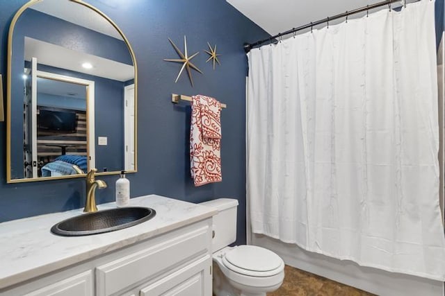 full bathroom featuring toilet, shower / bath combination with curtain, and vanity