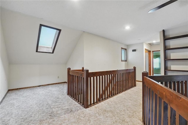 10503 W 50th Ter, Shawnee, KS 66203 - hall with a skylight, carpet flooring, an upstairs landing, plenty of natural light, and vaulted ceiling