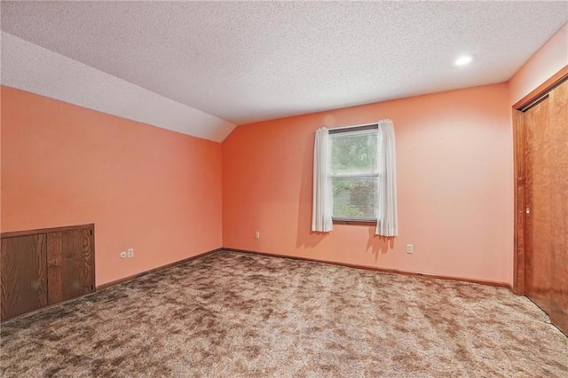 10503 W 50th Ter, Shawnee, KS 66203 - unfurnished bedroom featuring carpet, a textured ceiling, lofted ceiling, and baseboards