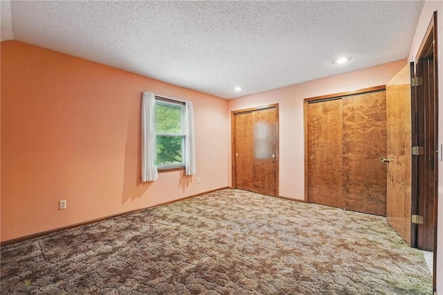 10503 W 50th Ter, Shawnee, KS 66203 - unfurnished bedroom featuring two closets, carpet, a textured ceiling, recessed lighting, and vaulted ceiling