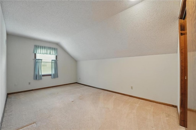 10503 W 50th Ter, Shawnee, KS 66203 - additional living space with a textured ceiling, lofted ceiling, light colored carpet, and baseboards