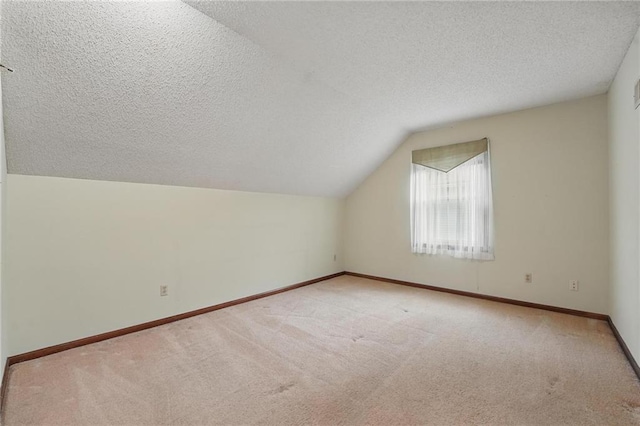 10503 W 50th Ter, Shawnee, KS 66203 - bonus room featuring a textured ceiling, carpet, vaulted ceiling, and baseboards
