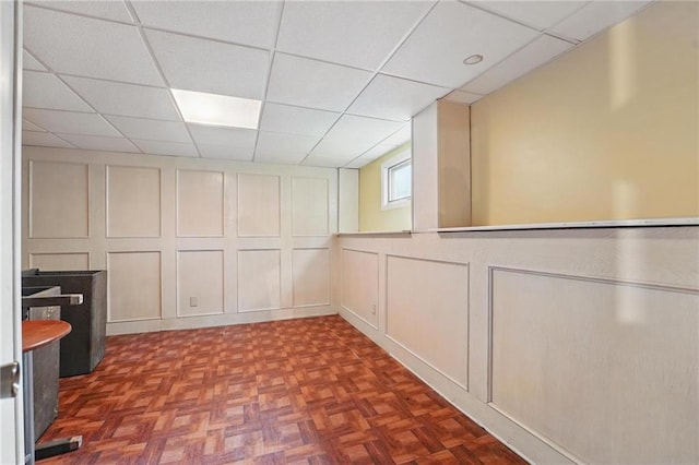 10503 W 50th Ter, Shawnee, KS 66203 - unfurnished dining area featuring a decorative wall and a drop ceiling