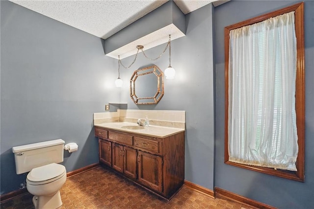 10503 W 50th Ter, Shawnee, KS 66203 - half bath featuring toilet, baseboards, vanity, and a textured ceiling