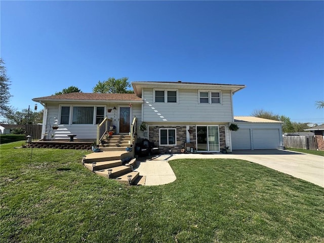 166 Crescent Dr, Chillicothe, MO 64601 - tri-level home featuring concrete driveway, a front lawn, fence, and stone siding