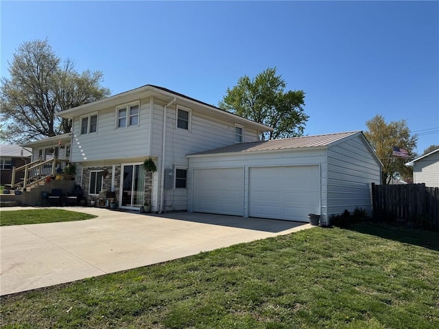 166 Crescent Dr, Chillicothe, MO 64601 - view of front of home with a garage, driveway, a front lawn, and fence