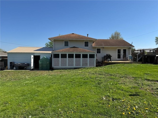 166 Crescent Dr, Chillicothe, MO 64601 - back of house featuring a wooden deck and a lawn