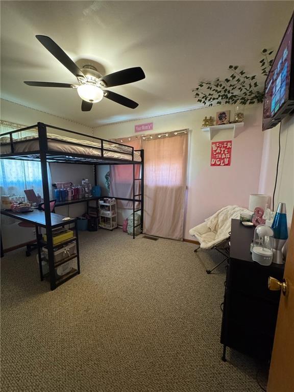 166 Crescent Dr, Chillicothe, MO 64601 - bedroom with ceiling fan and carpet flooring