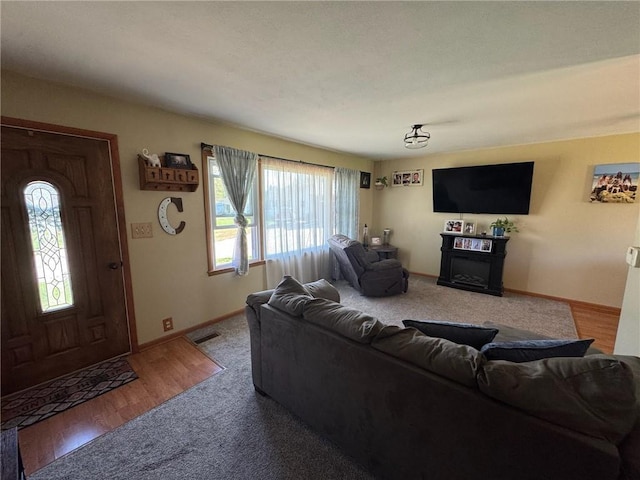 166 Crescent Dr, Chillicothe, MO 64601 - living area with baseboards, visible vents, a fireplace, and carpet