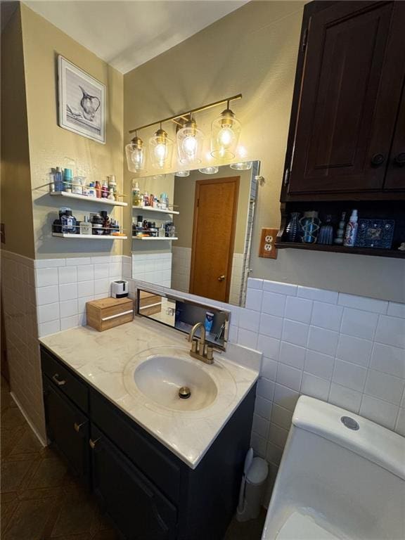 166 Crescent Dr, Chillicothe, MO 64601 - bathroom with tile walls, wainscoting, and vanity