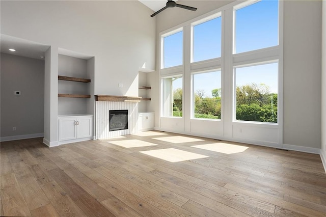 unfurnished living room with plenty of natural light and a towering ceiling