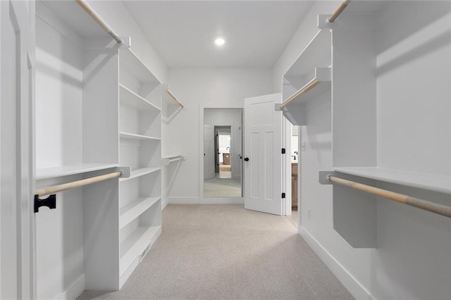 spacious closet featuring light carpet