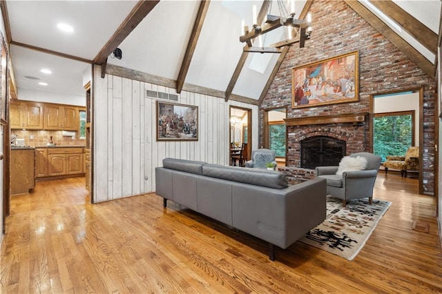4710 Monrovia St, Shawnee, KS 66216 - living room with high vaulted ceiling, light wood finished floors, beam ceiling, and a brick fireplace