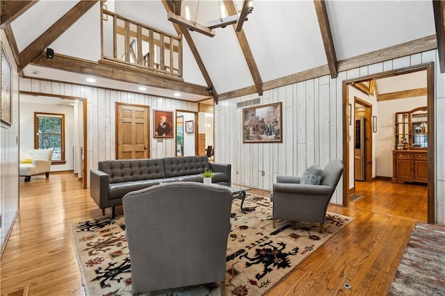 4710 Monrovia St, Shawnee, KS 66216 - living area featuring high vaulted ceiling, a chandelier, light wood-type flooring, wood walls, and beam ceiling