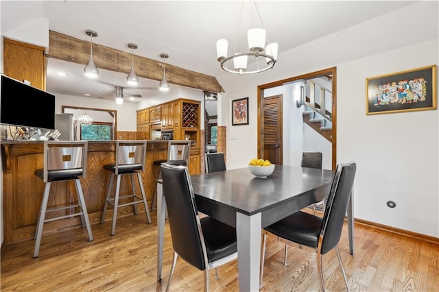 4710 Monrovia St, Shawnee, KS 66216 - dining room featuring a chandelier, stairs, light wood finished floors, and beam ceiling