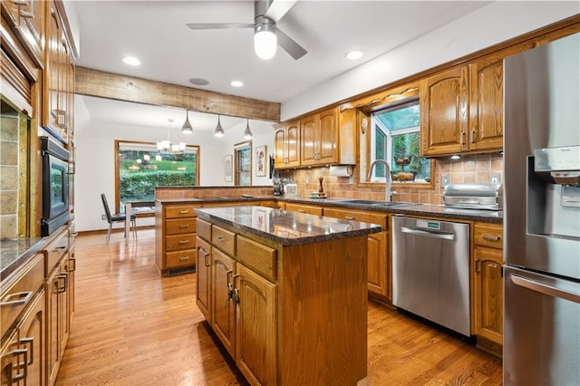 4710 Monrovia St, Shawnee, KS 66216 - kitchen with stainless steel appliances, brown cabinetry, a peninsula, recessed lighting, and beamed ceiling