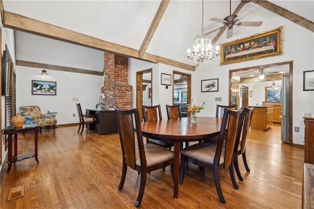 4710 Monrovia St, Shawnee, KS 66216 - dining room with beam ceiling, wood finished floors, a chandelier, high vaulted ceiling, and a ceiling fan