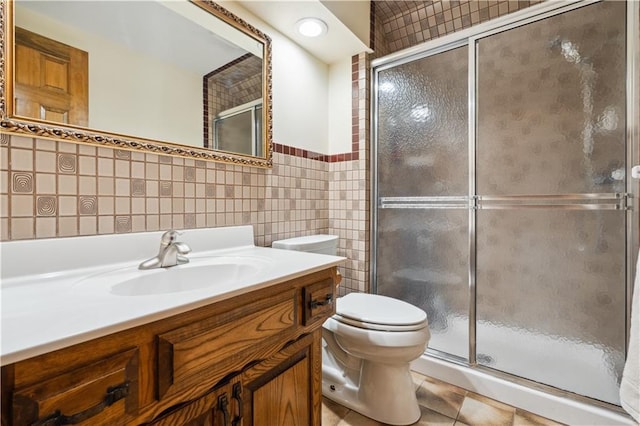 4710 Monrovia St, Shawnee, KS 66216 - full bath with tile walls, vanity, a stall shower, and tile patterned floors