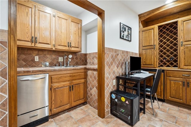 4710 Monrovia St, Shawnee, KS 66216 - bar with stainless steel dishwasher, stone tile floors, tile walls, and a wainscoted wall