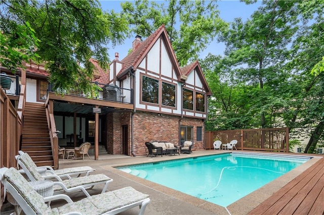 4710 Monrovia St, Shawnee, KS 66216 - outdoor pool with stairs, a wooden deck, a patio, and an outdoor living space