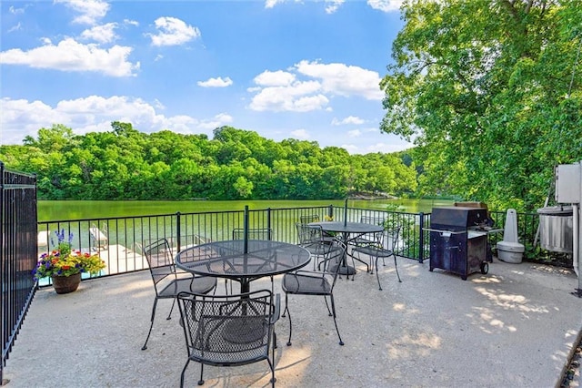 4710 Monrovia St, Shawnee, KS 66216 - view of patio with outdoor dining area, area for grilling, a water view, and a forest view