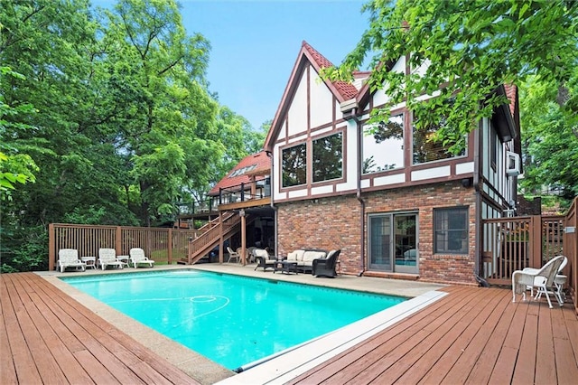 4710 Monrovia St, Shawnee, KS 66216 - swimming pool featuring stairway, a wooden deck, and an outdoor hangout area