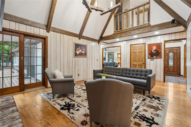 4710 Monrovia St, Shawnee, KS 66216 - living room featuring high vaulted ceiling, beamed ceiling, wood finished floors, and wooden walls