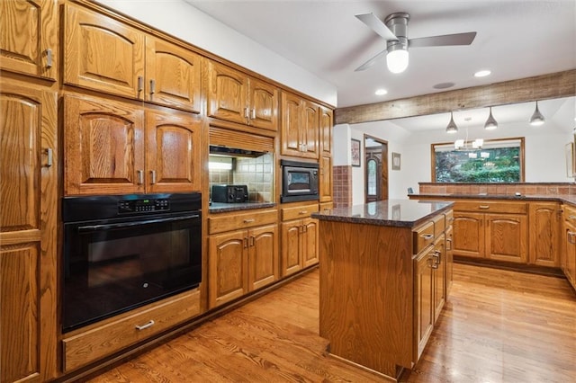 4710 Monrovia St, Shawnee, KS 66216 - kitchen featuring black appliances, light wood-style floors, a kitchen island, tasteful backsplash, and recessed lighting