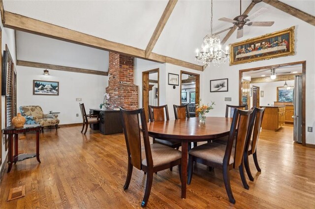 4710 Monrovia St, Shawnee, KS 66216 - dining room featuring beam ceiling, wood finished floors, a chandelier, high vaulted ceiling, and a ceiling fan