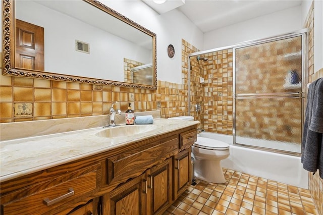 4710 Monrovia St, Shawnee, KS 66216 - full bath with tile walls, vanity, and bath / shower combo with glass door