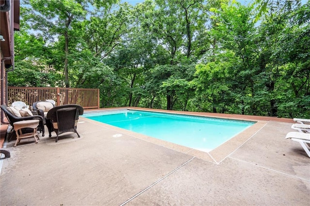 4710 Monrovia St, Shawnee, KS 66216 - outdoor pool with view of wooded area and a patio area
