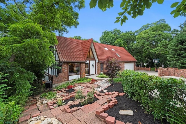 4710 Monrovia St, Shawnee, KS 66216 - back of property featuring brick siding, a tiled roof, and an attached garage