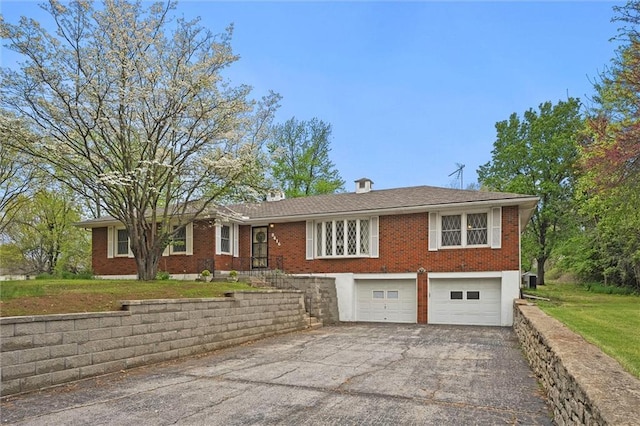 8416 Westridge Rd, Raytown, MO 64138 - ranch-style home featuring brick siding, a front yard, an attached garage, and aphalt driveway
