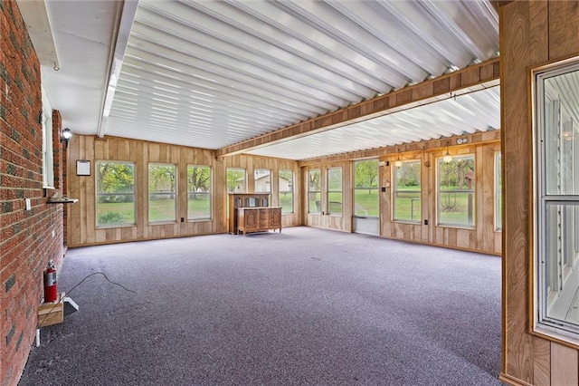 8416 Westridge Rd, Raytown, MO 64138 - unfurnished sunroom with wooden walls, carpet flooring, and brick wall
