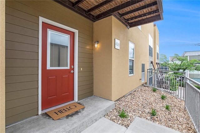4581 Madison Ave, Kansas City, MO 64111 - property entrance with a balcony and stucco siding