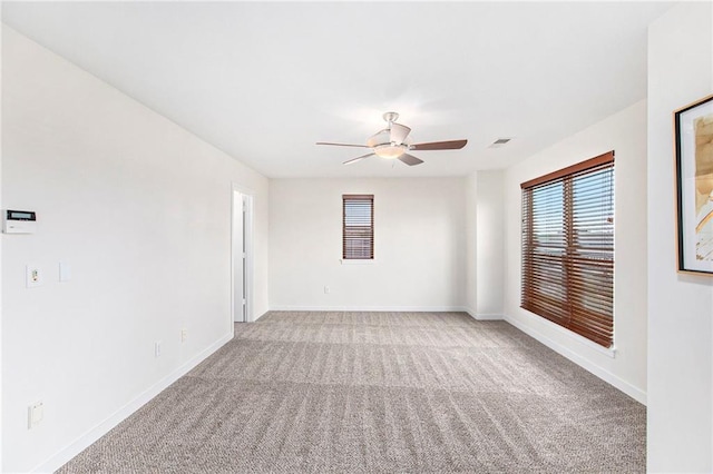 4581 Madison Ave, Kansas City, MO 64111 - empty room with a ceiling fan, light carpet, and baseboards