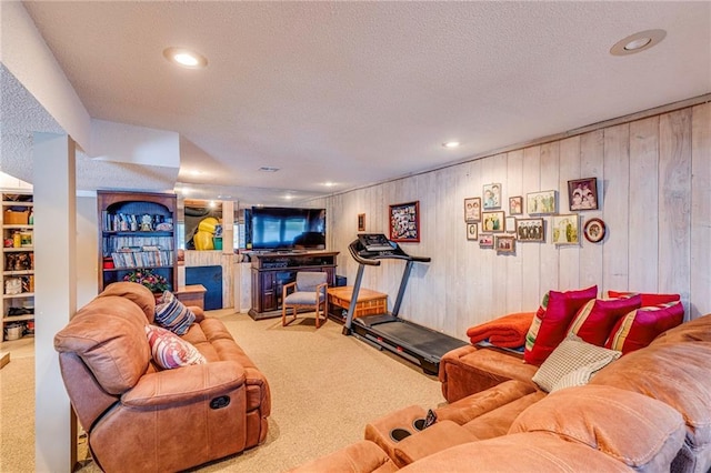 521 W Sugar Lake Dr, Mound City, KS 66056 - living area with carpet, a textured ceiling, a fireplace, wood walls, and recessed lighting